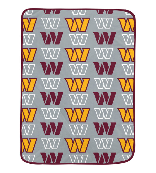 Commanders blanket with patterned design on a gray background
